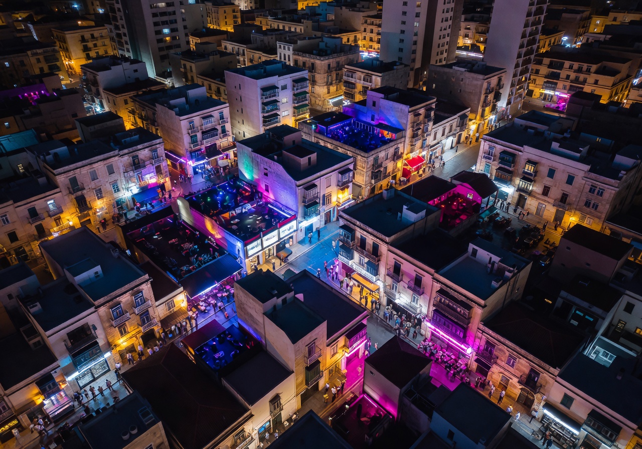 Aerial view of Paceville Malta nightlife district glowing at night